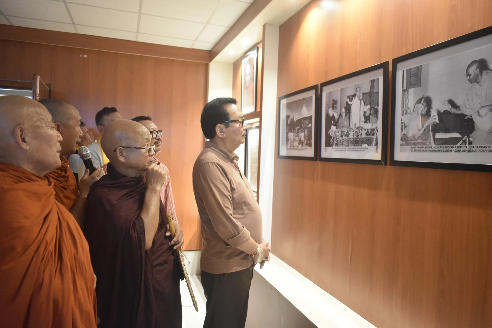 Visitors viewing a display of photographs